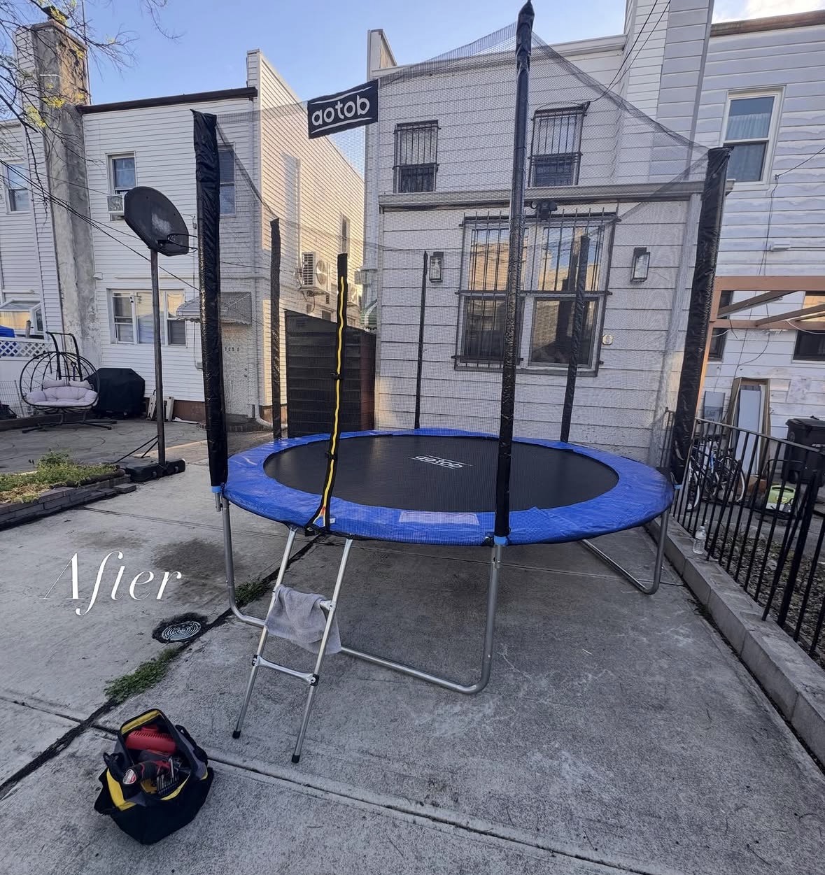 Completed outdoor trampoline with safety enclosure